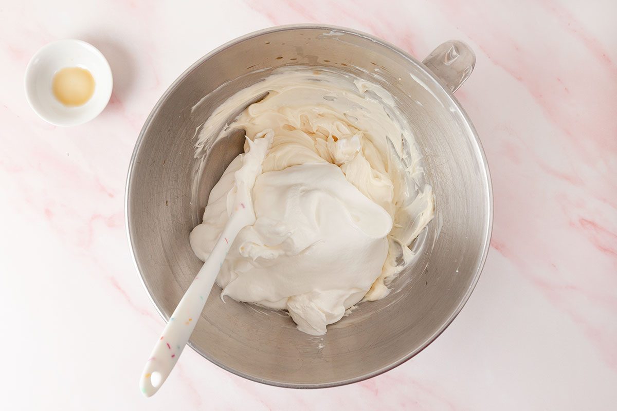 a stand mixer fitted with a paddle attachment; beat cream cheese