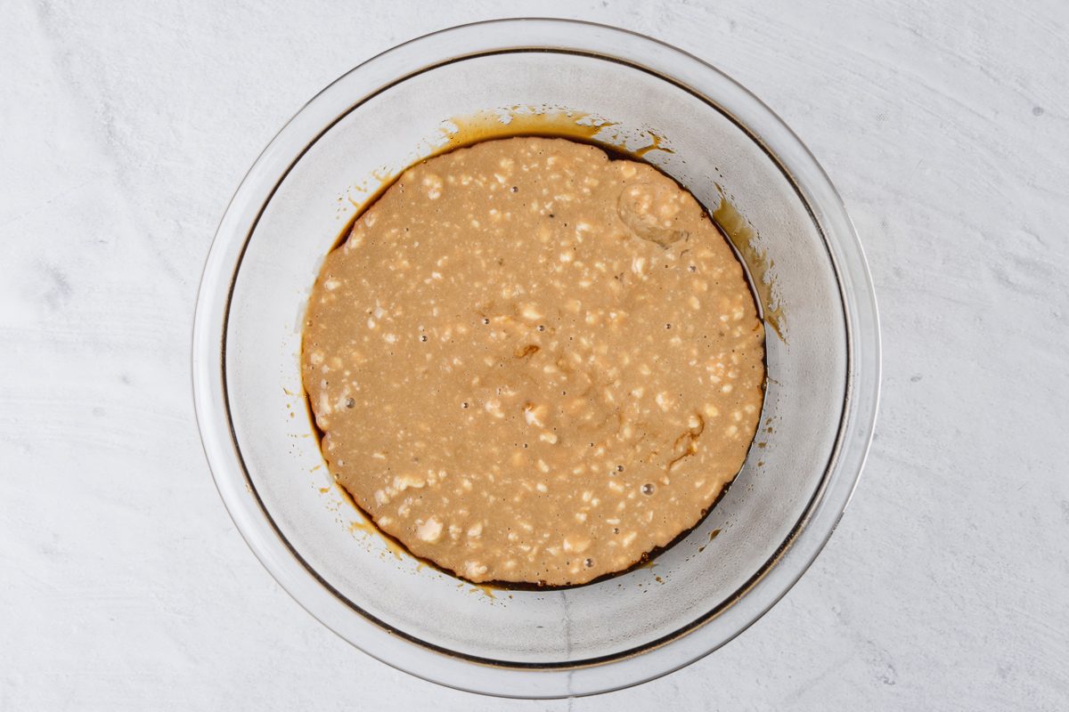 pudding mixture poured into bowl layered with golden syrup and molasses