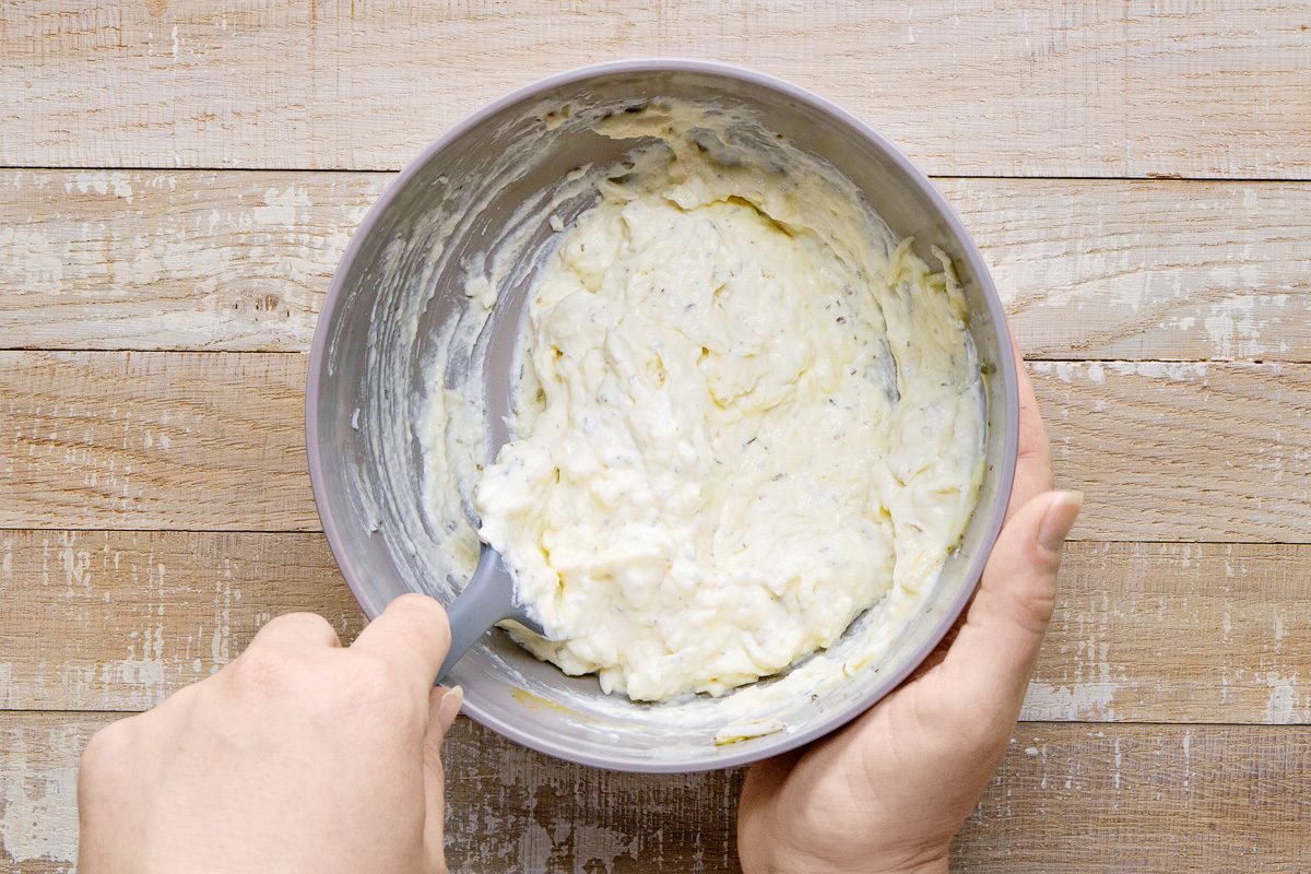 ricotta, egg, cheese and Italian seasoning being mixed in a bowl