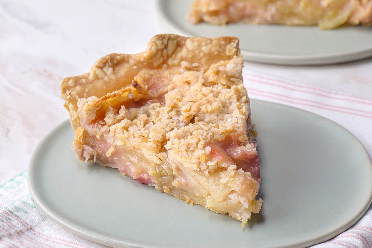 A slice apple rhubarb pie that shows the layer of pie from inside 