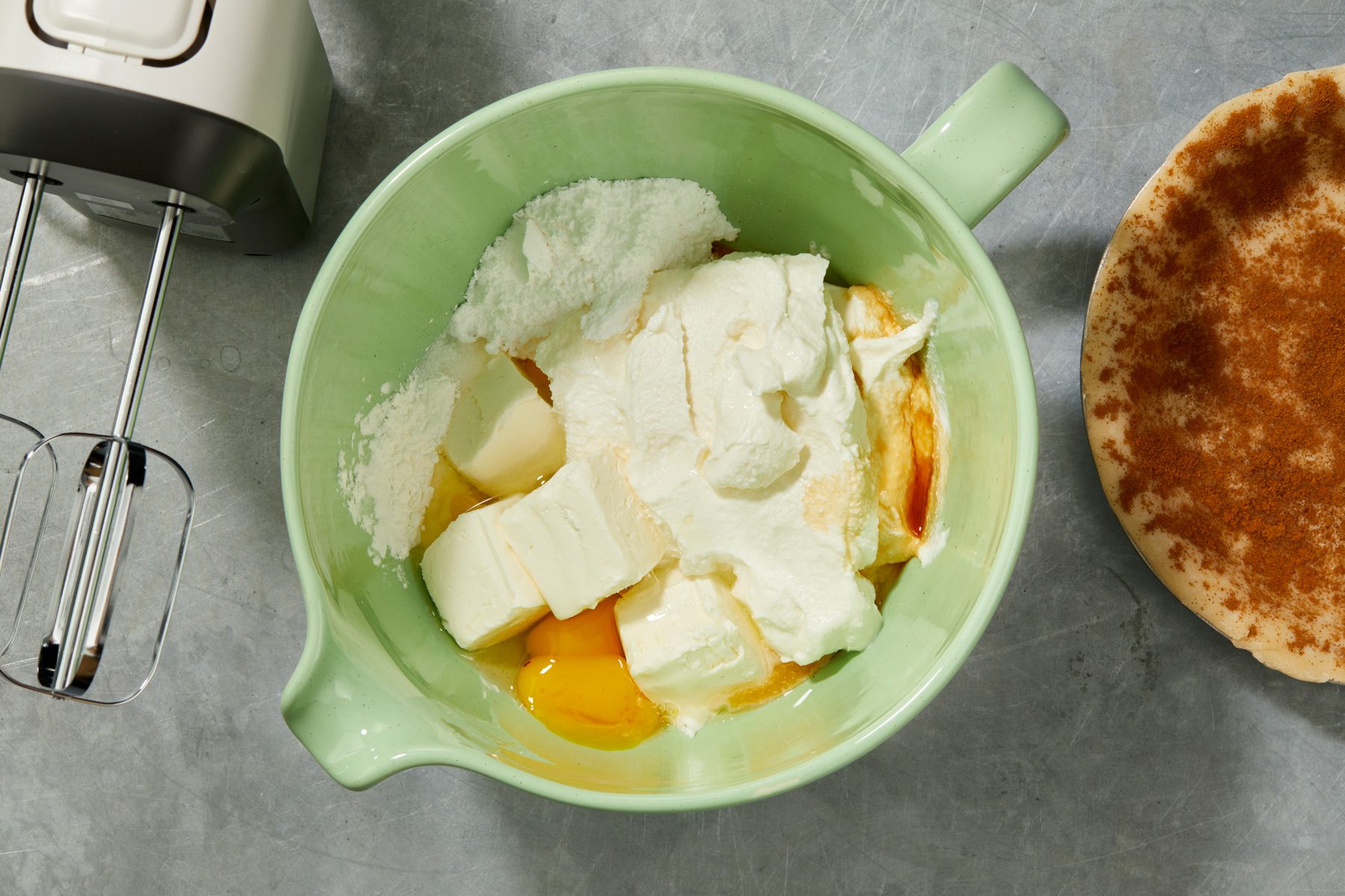 In a large bowl combine the cheeses; confectioners sugar; cornstarch; vanilla; salt and egg mixture; Pour into prepared pastry