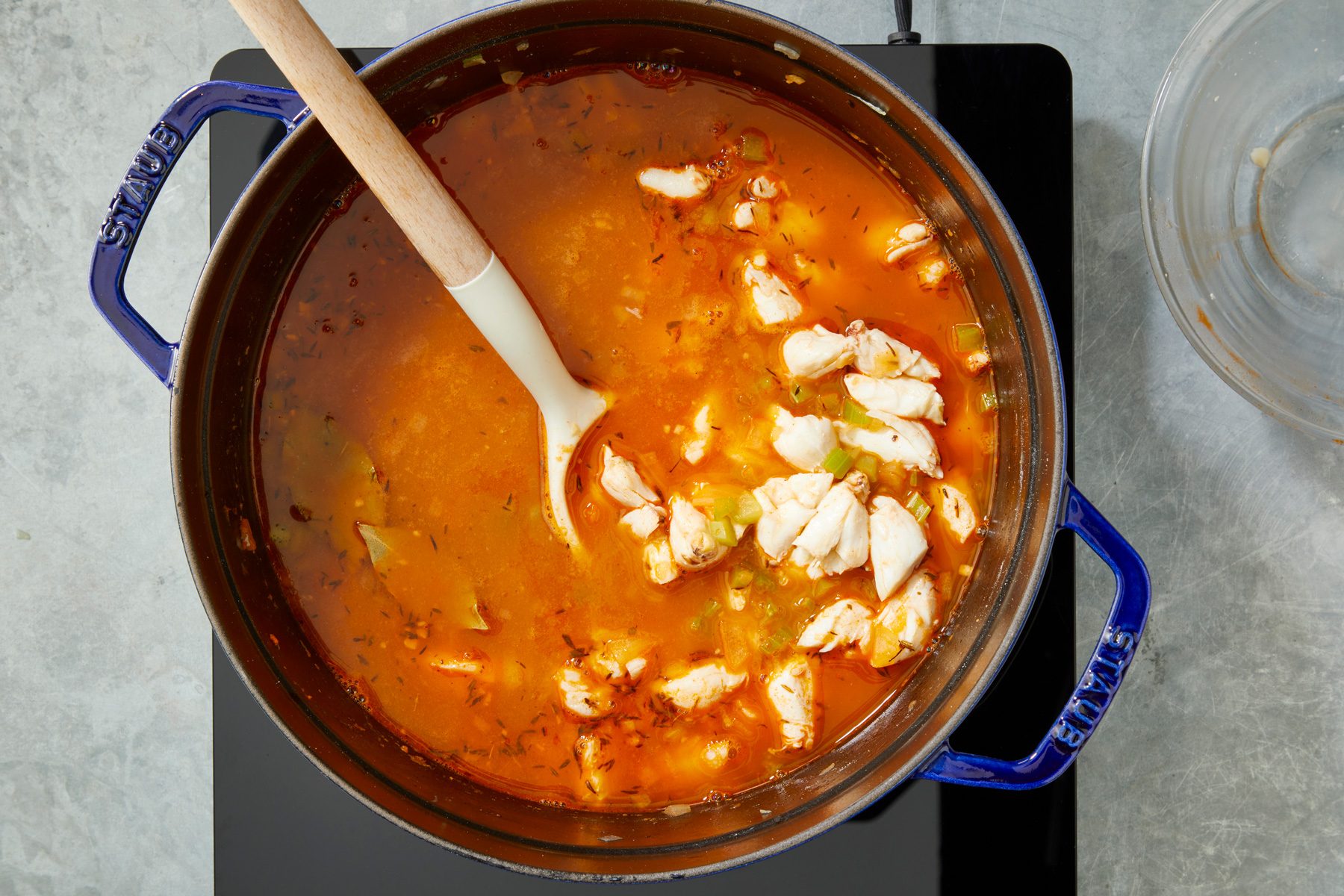 Overhead shot of reduce heat; simmer uncovered 20-25 minutes to allow flavors to blend; spoon; induction; grey surface;
