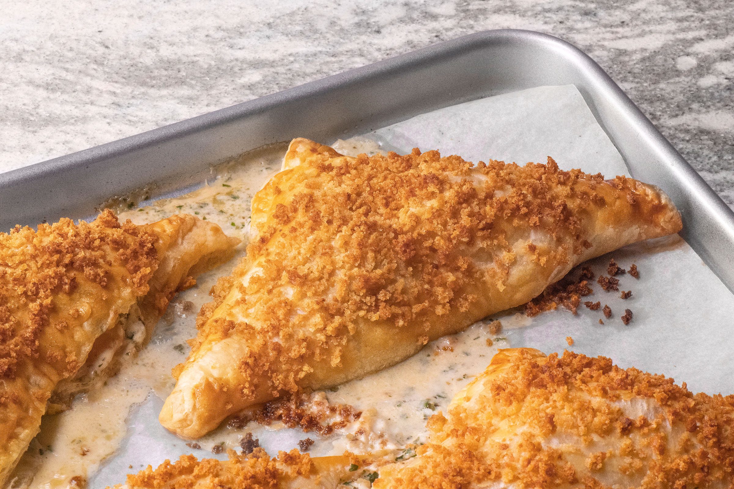 Shrimp Puff Pastry Triangles on a parchment-lined baking sheet.