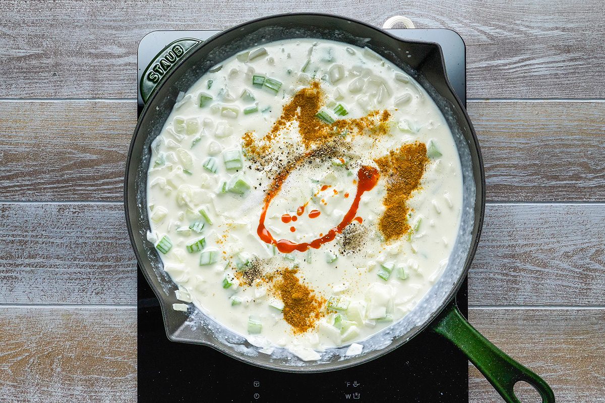 Add whisked cream;seafood seasoning; salt; pepper sauce and pepper into the skillet