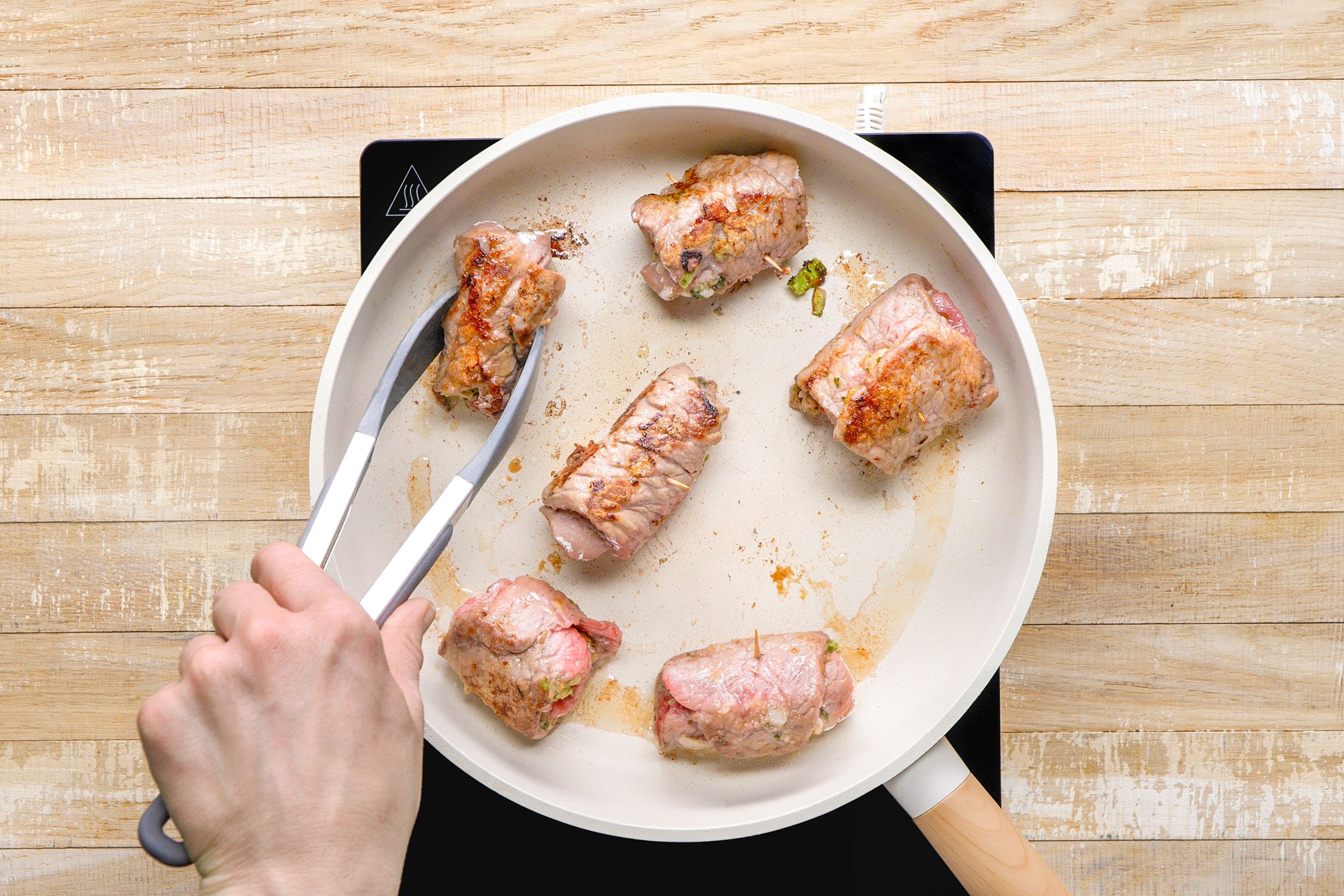 In a large skillet, browning up the roll-ups in canola oil.