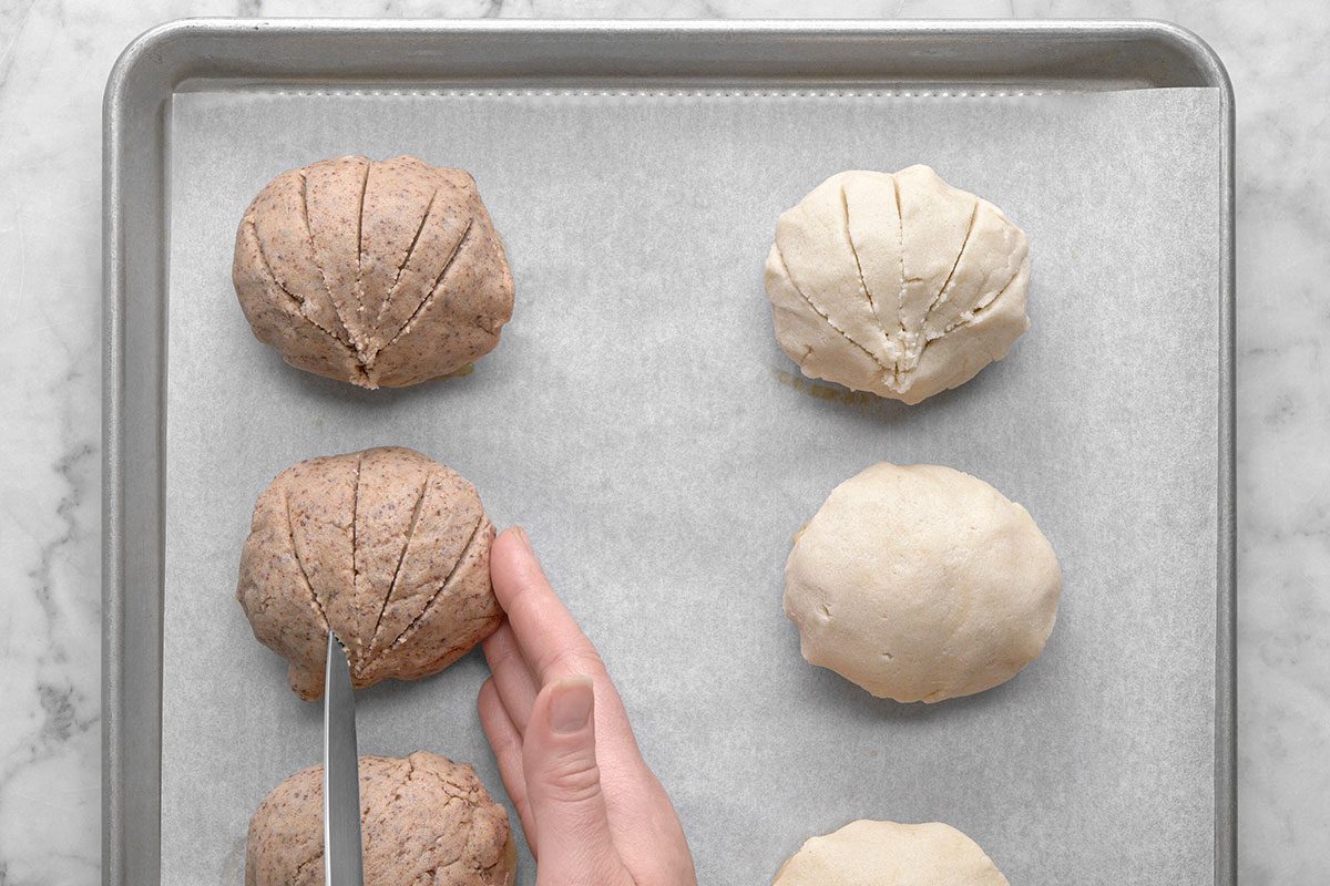 A knife is making a cut on the topping