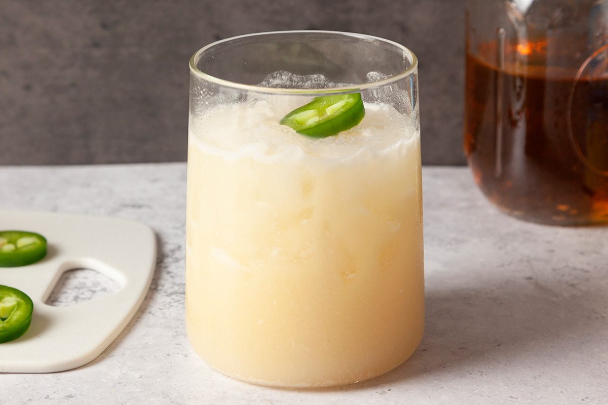 3/4 shot of Cowboy Colada garnished with a jalapeno round.
