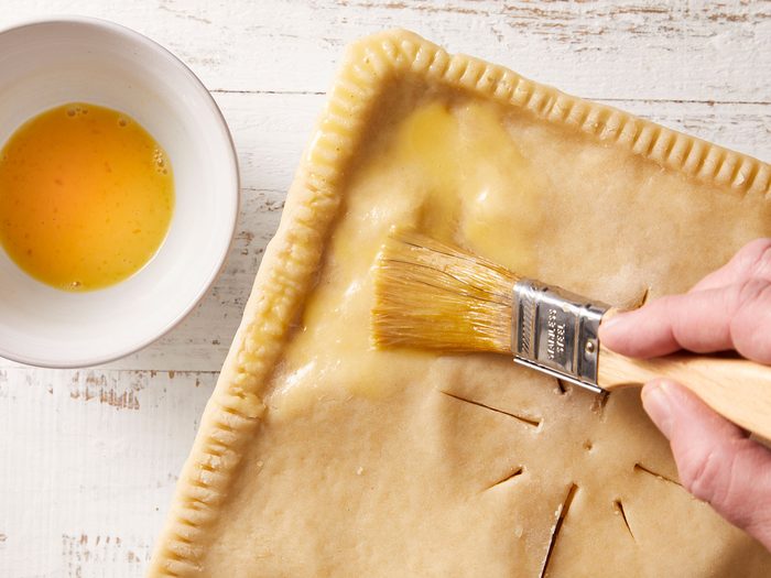 Brush egg mixture over pie