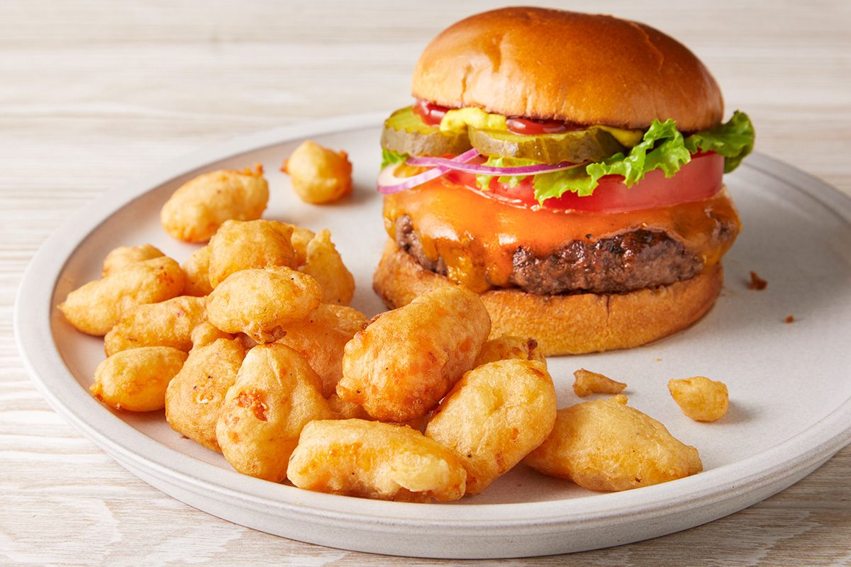 3/4 shot of Wisconsin Fried Cheese Curds served with a Burger