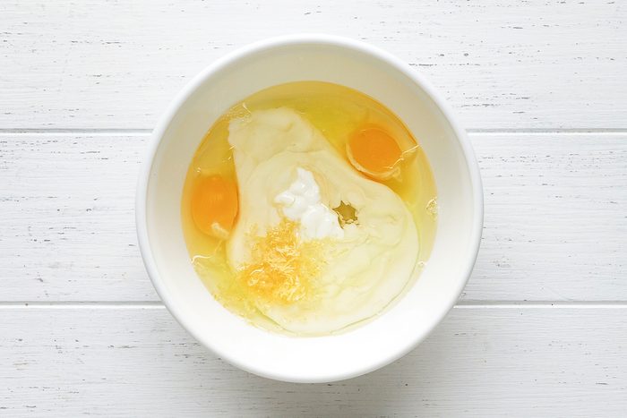 eggs, yogurt, oil and lemon zest in a bowl