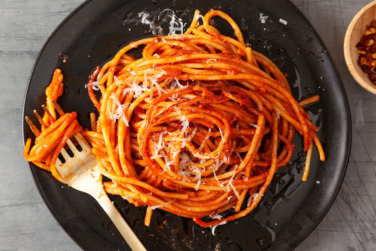 Spaghetti all'Assassina is ready and served in plates and prinkle with grated Pecorino Romano or Parmesan cheese; if desired; Serve hot