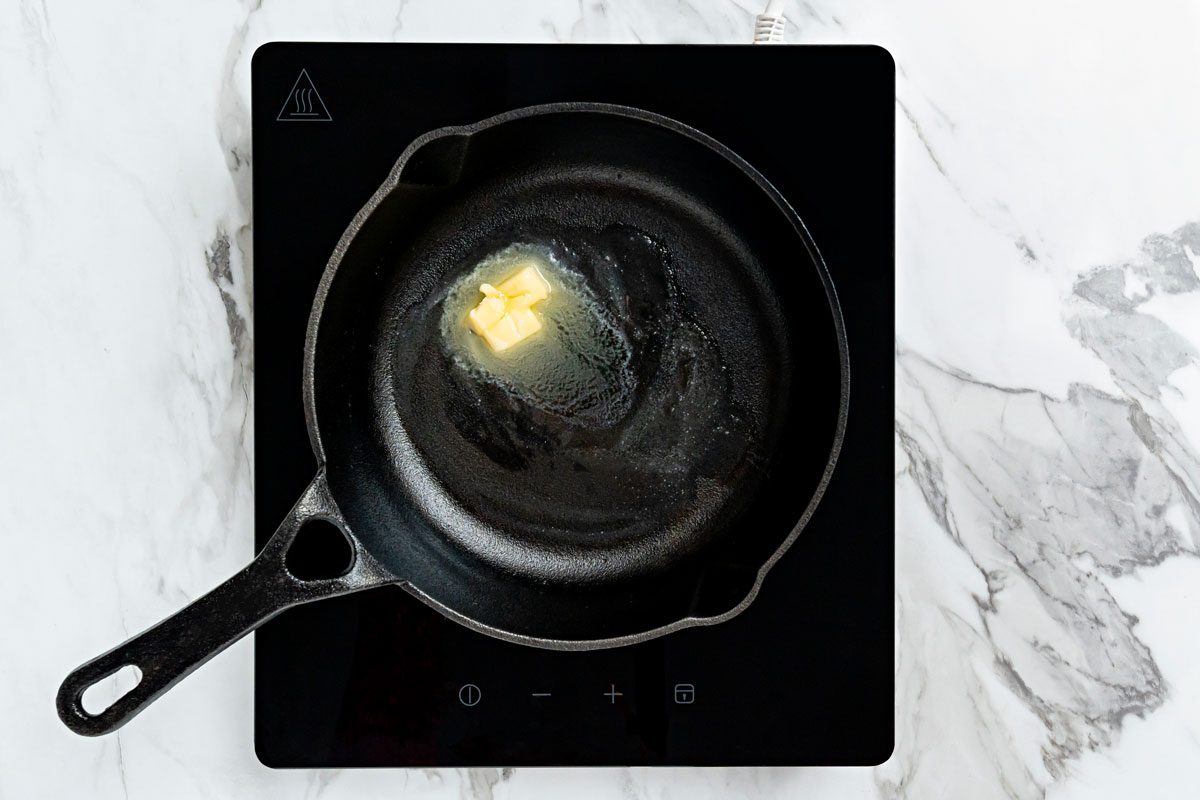 In a cast-iron or other heavy skillet, heat butter over medium-high heat.