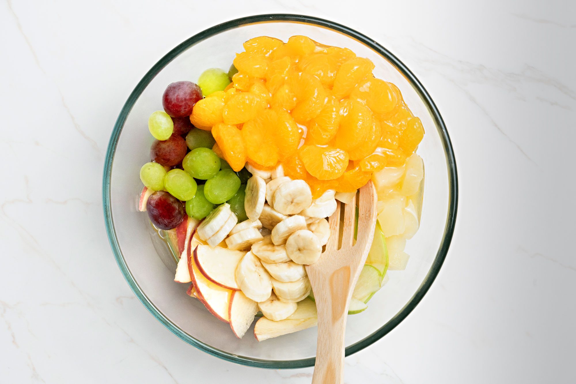 combine all the fruits together with a spatula