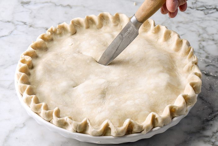 adding slashes to pie crust with a knife