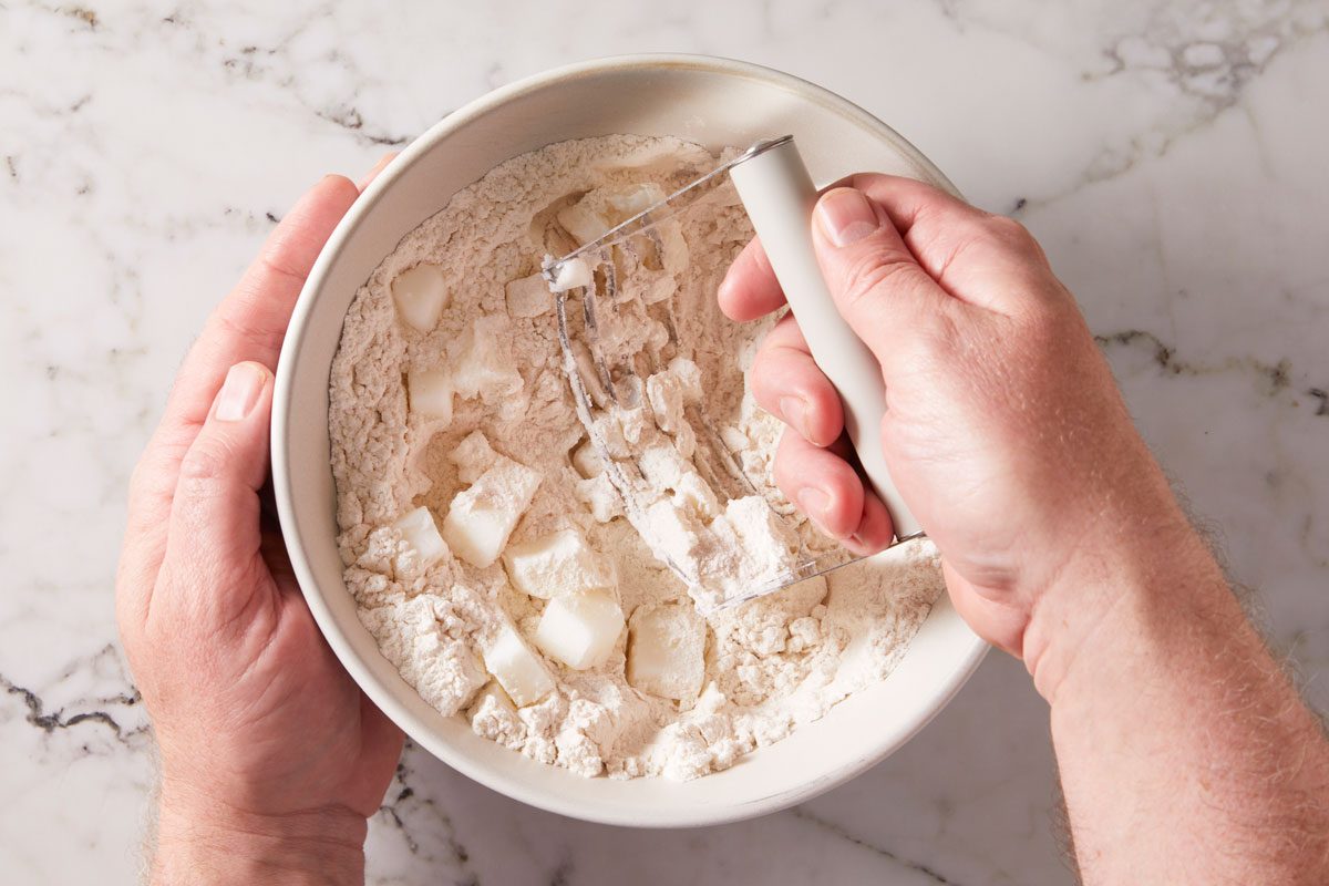 In a small bowl, mix flour and salt; cut in lard until crumbly.