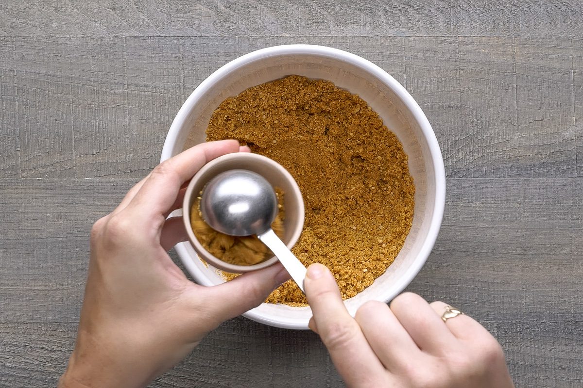 scooping out crumb crust mixture