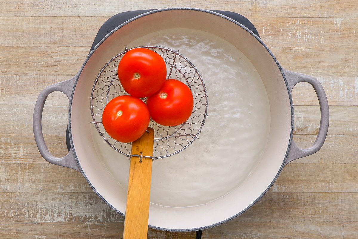 tomatoes being placed in water