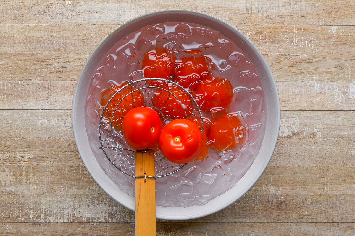 tomatoes being plunged into ice water