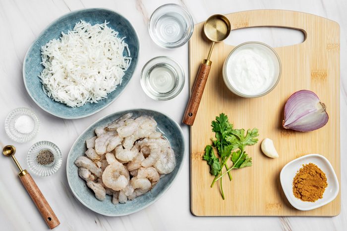 Olive oil Onion Shrimp Garlic Curry powder Greek yogurt Cilantro Water Salt and pepper Hot cooked rice