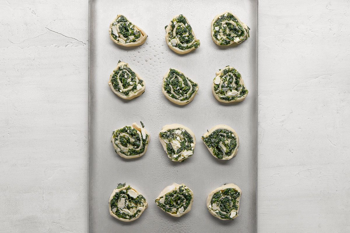 Place cut side down on greased baking sheets.