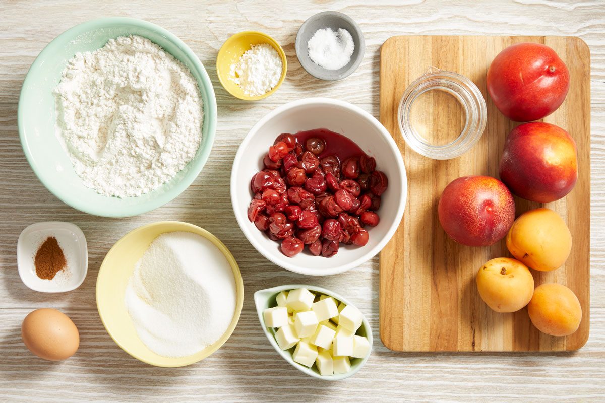 Overhead shot of ingredients on the kitchen counter for Stone Fruit Pie