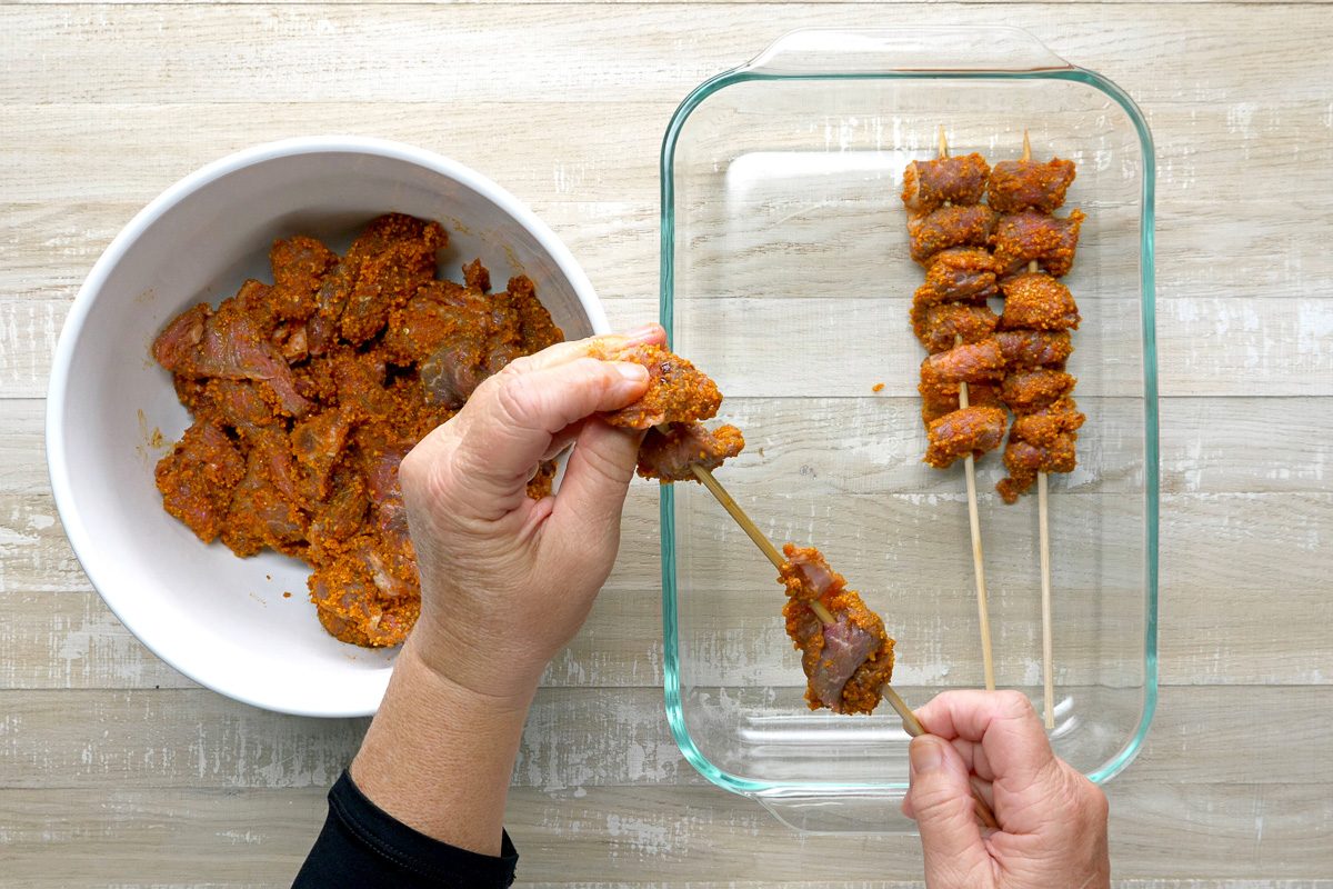 Threading beef onto metal or soaked wooden skewers