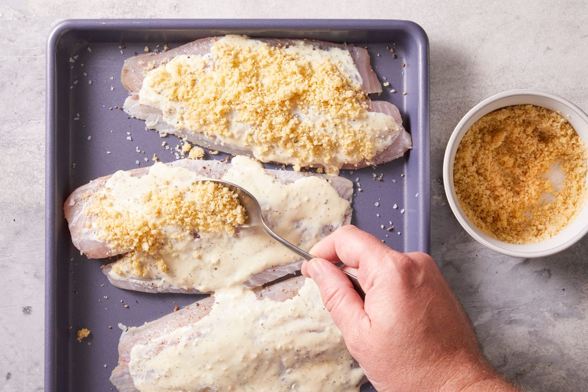 Toss bread crumbs with melted butter and remaining cheese;