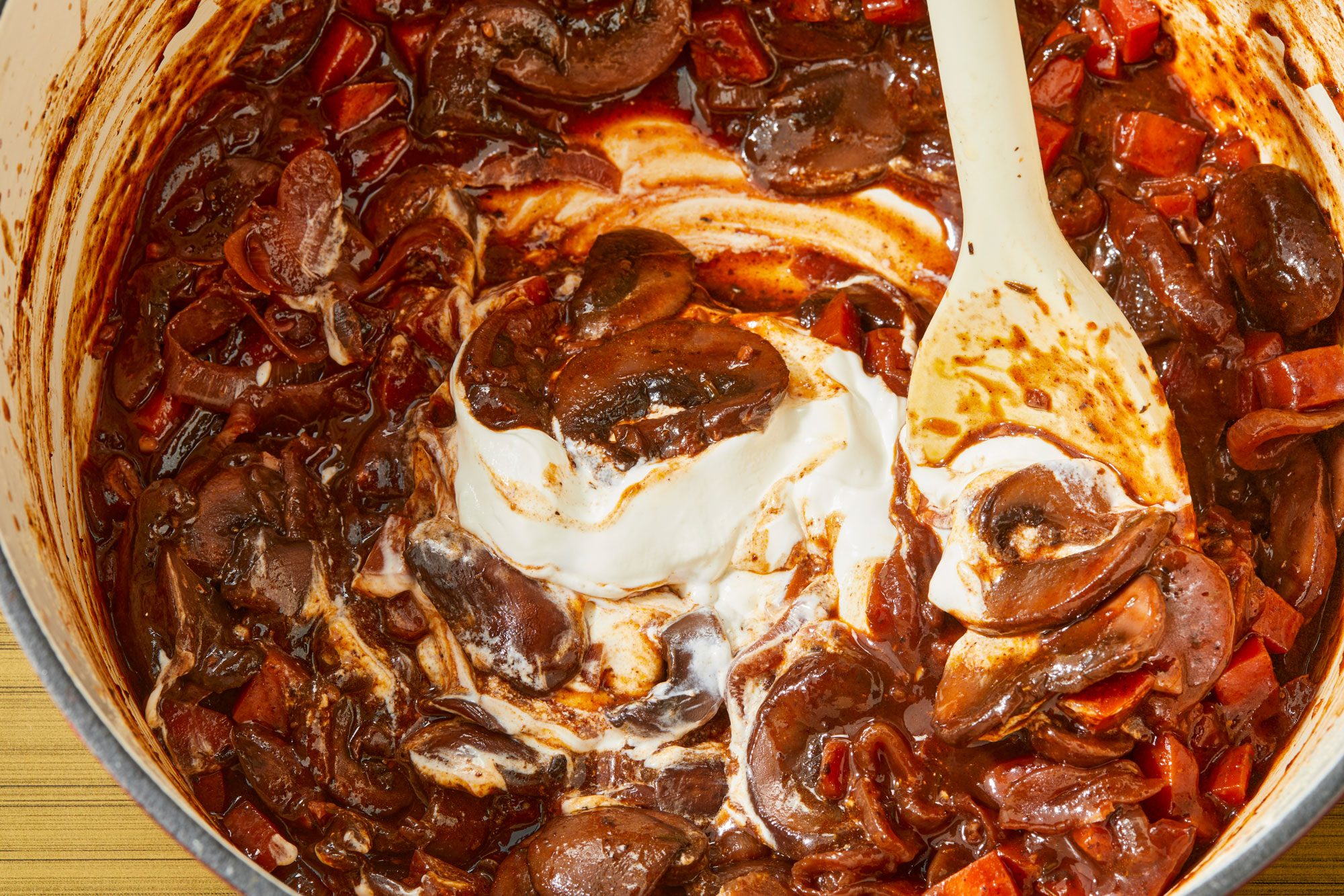 Close shot of discard bay leaf; stir in sour cream; Serve over hot polenta or mashed potatoes; spoon; induction;