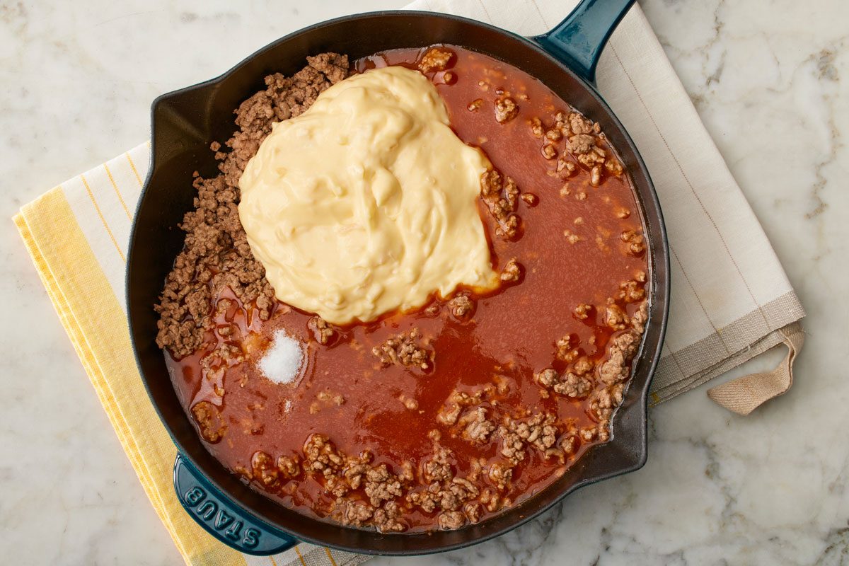 Stir in enchilada sauce, soup and salt.