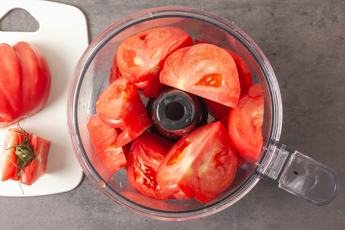 Put the quartered tomatoes into a blender or food processor