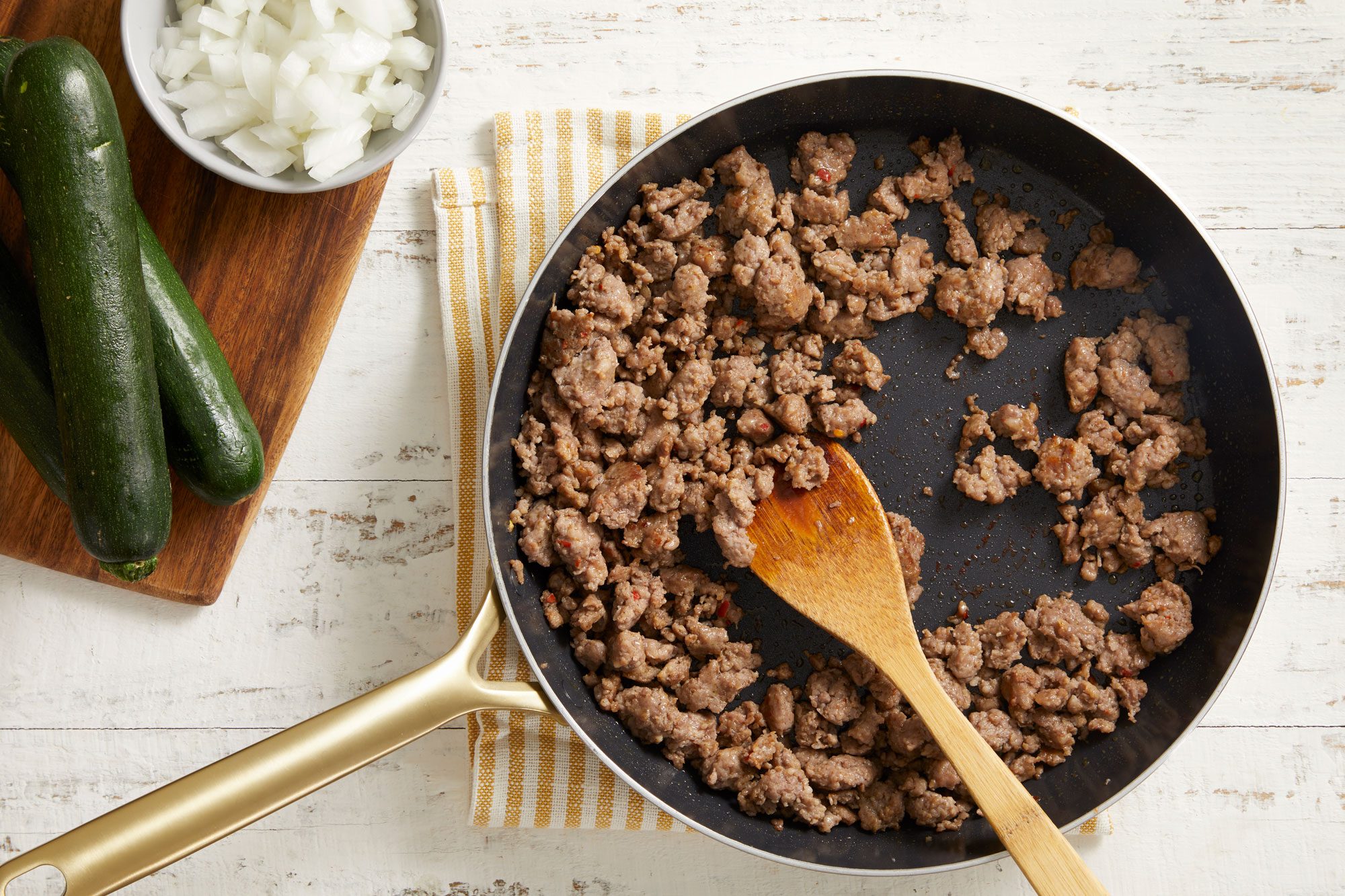 In a large skillet, cook sausage until no longer pink,