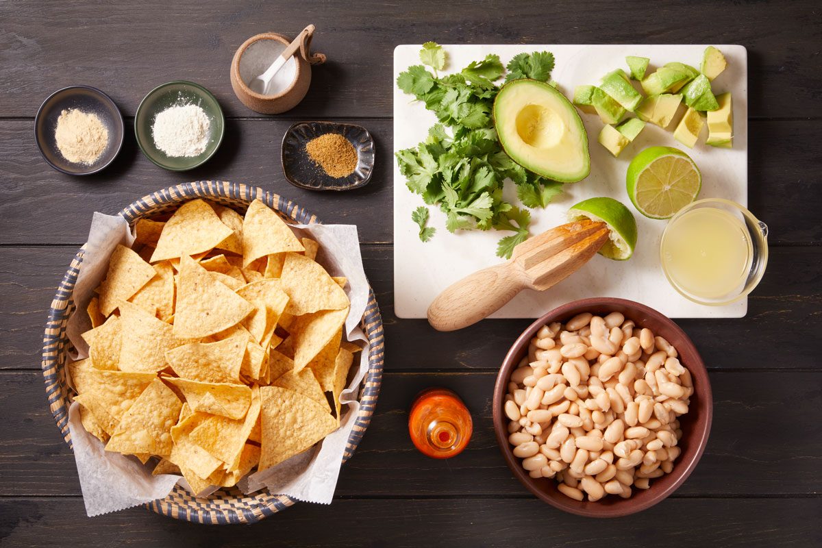 Cannellini beans Avocado Fresh cilantro leaves Lime juice Onion powder Garlic powder Chipotle hot pepper sauce Salt Ground cumin Baked tortilla chips