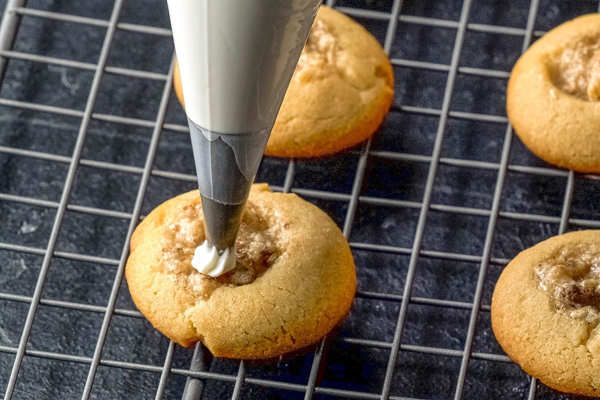 Close-up shot of cool for 1 minute before removing from pans to wire racks; top with frosting; dark surface