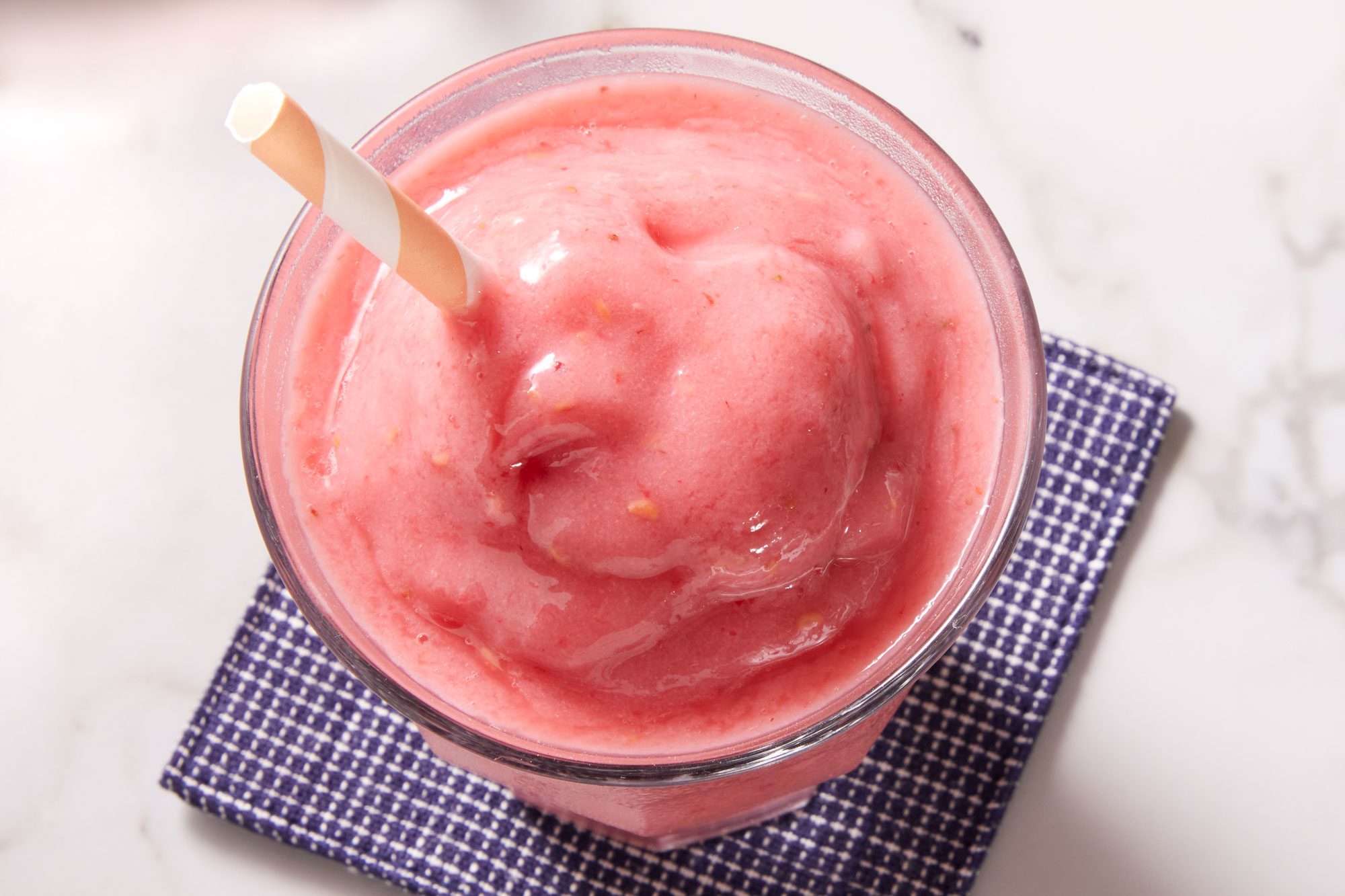 Close up shot of Fruity Red Smoothies garnished with mint sprigs and fresh strawberries