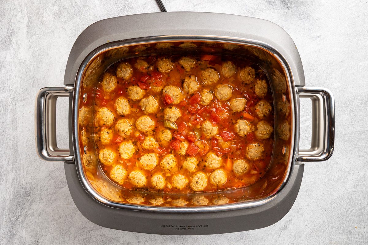 carrots, celery, onion, bay leaf, Italian seasoning, pepper, meatballs, broth, tomatoes, water and wine in a 6-quart slow cooker