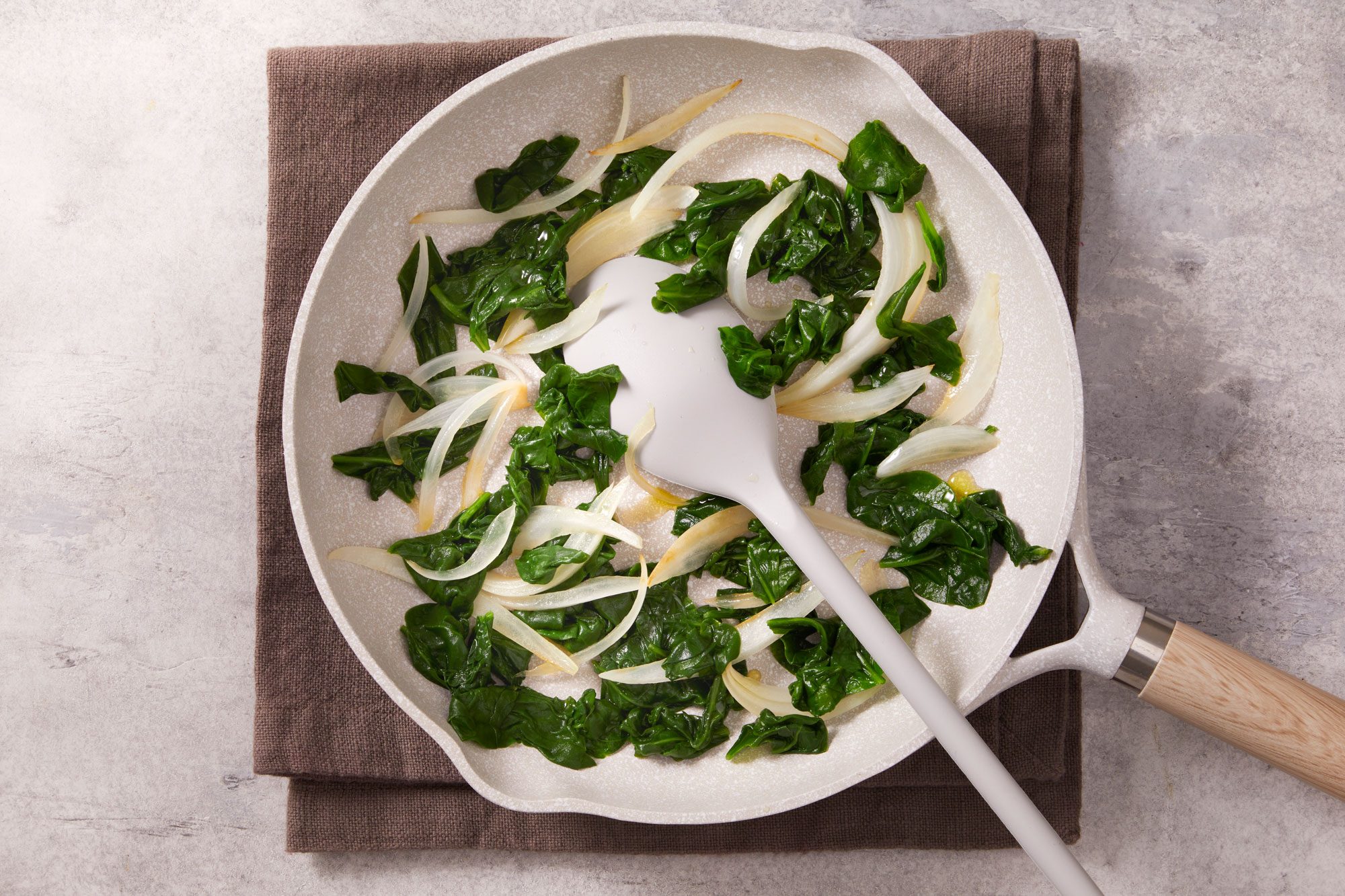 Cook onion and spinach until onion is tender