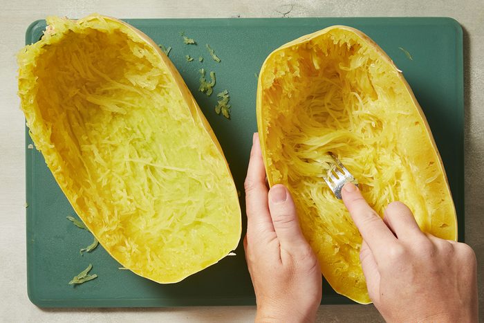 Separate the flesh from the strands using a fork in a squash