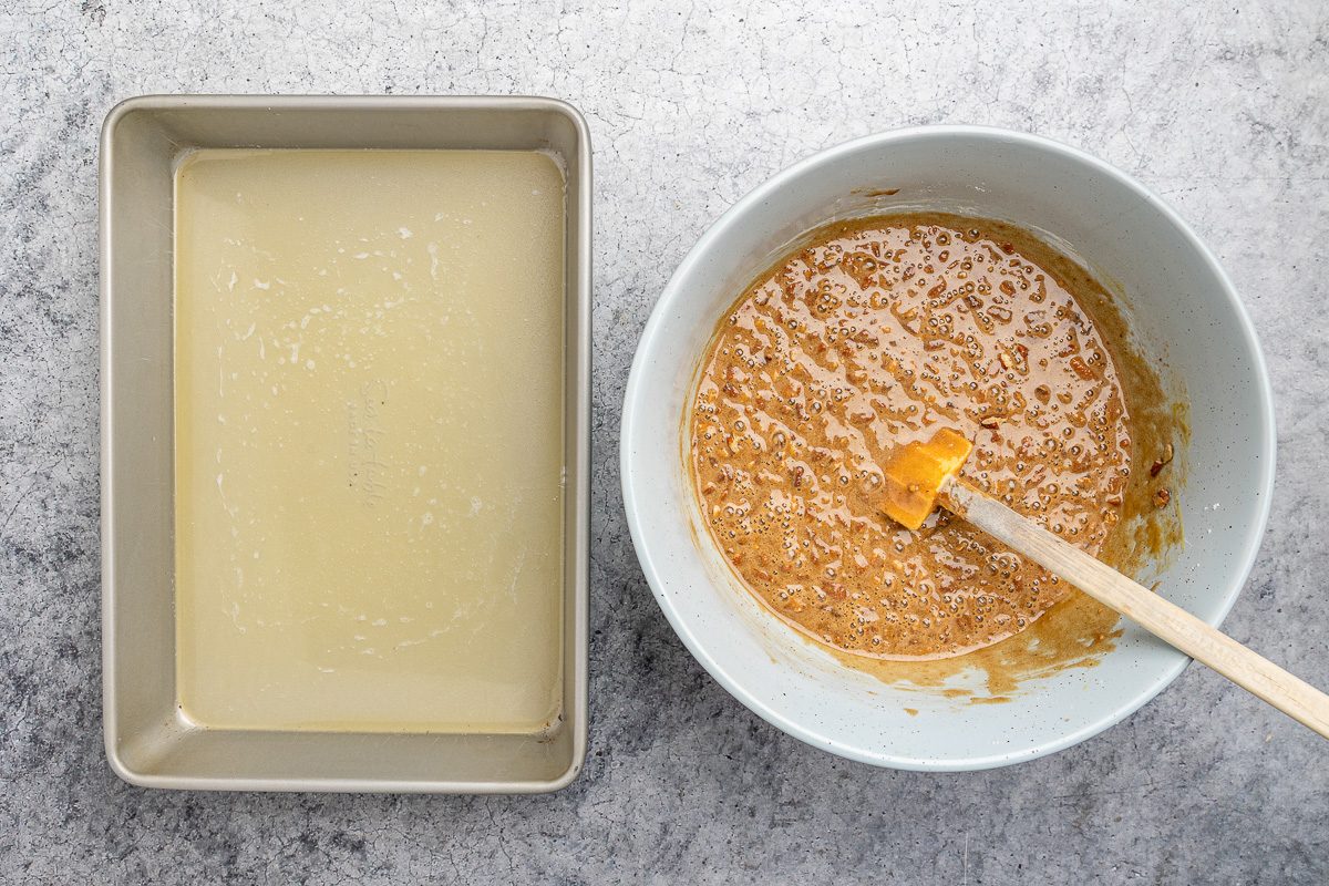brown sugar, flour, eggs, vanilla, baking soda, salt and chopped pecans mixture next to melted butter in a baking pan