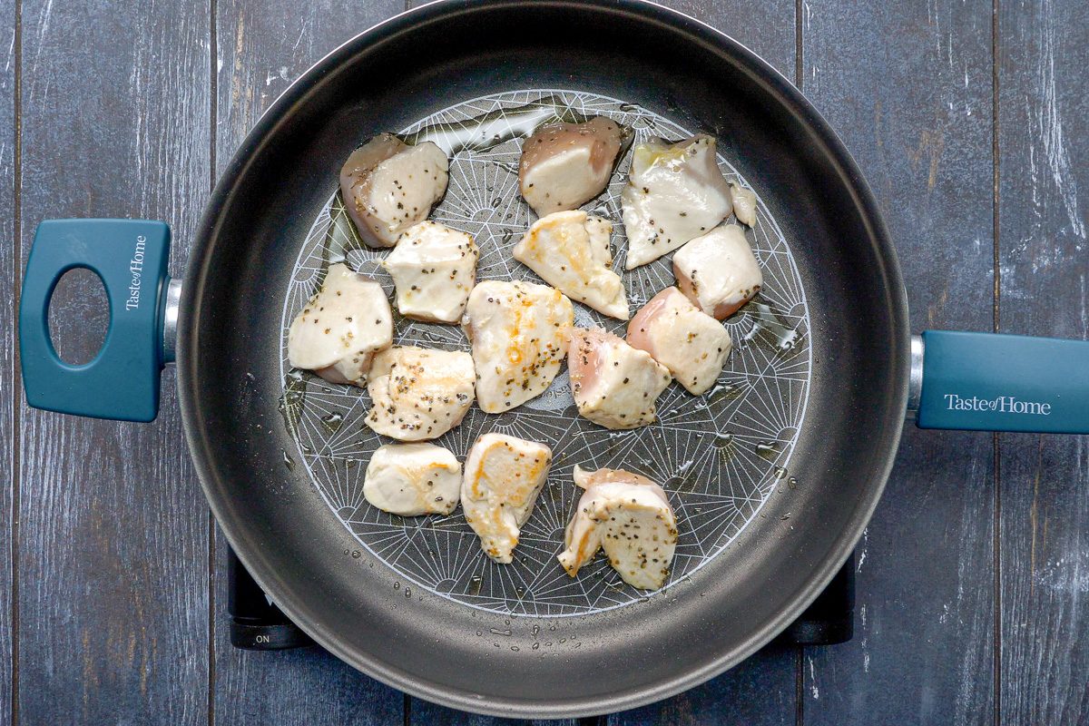 chicken being cooked in a skillet