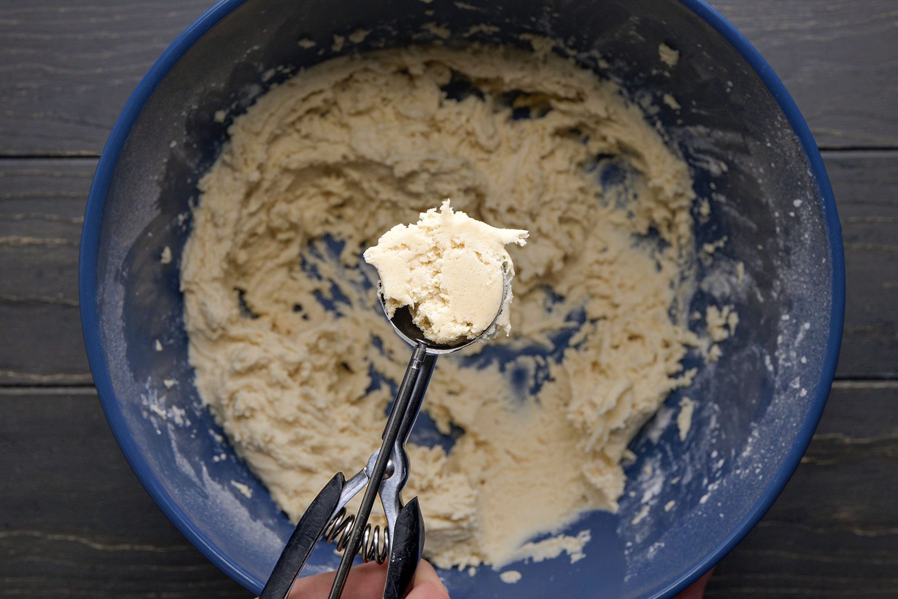 Shape the cookie dough into 1-inch balls using a scooper spoon.