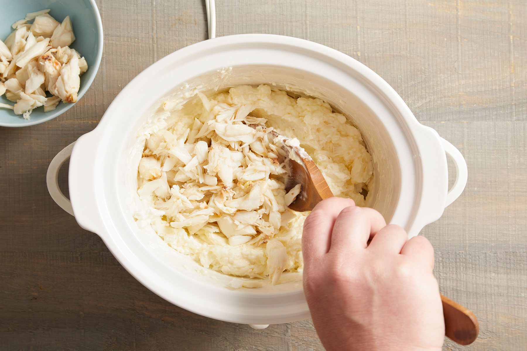 Gently folding in the crab meat in cheese, onion, mayonnaise, minced garlic and sugar. 