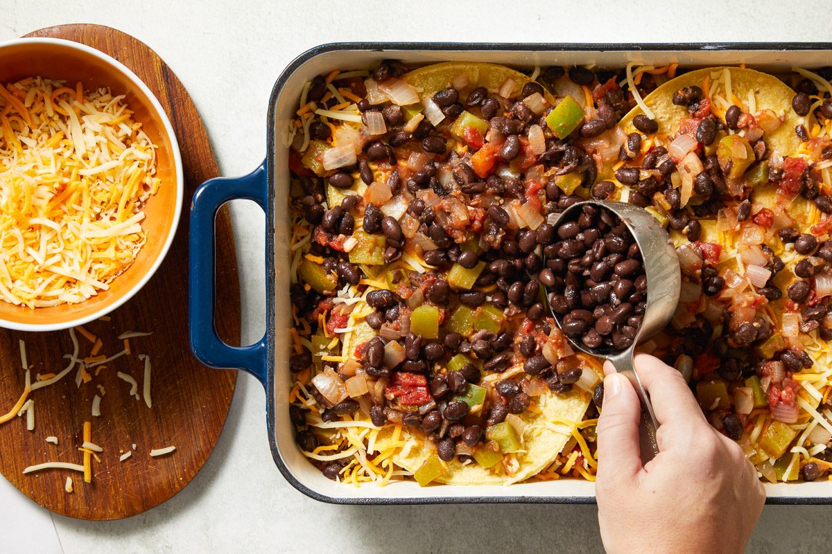 beans being added to final layer of casserole